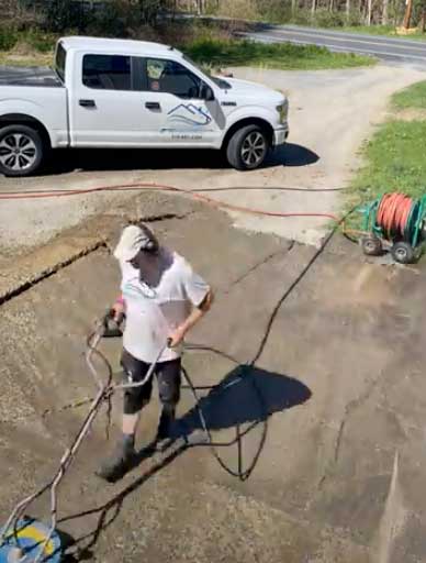 A professional pressure washer hard at work on your patio.
